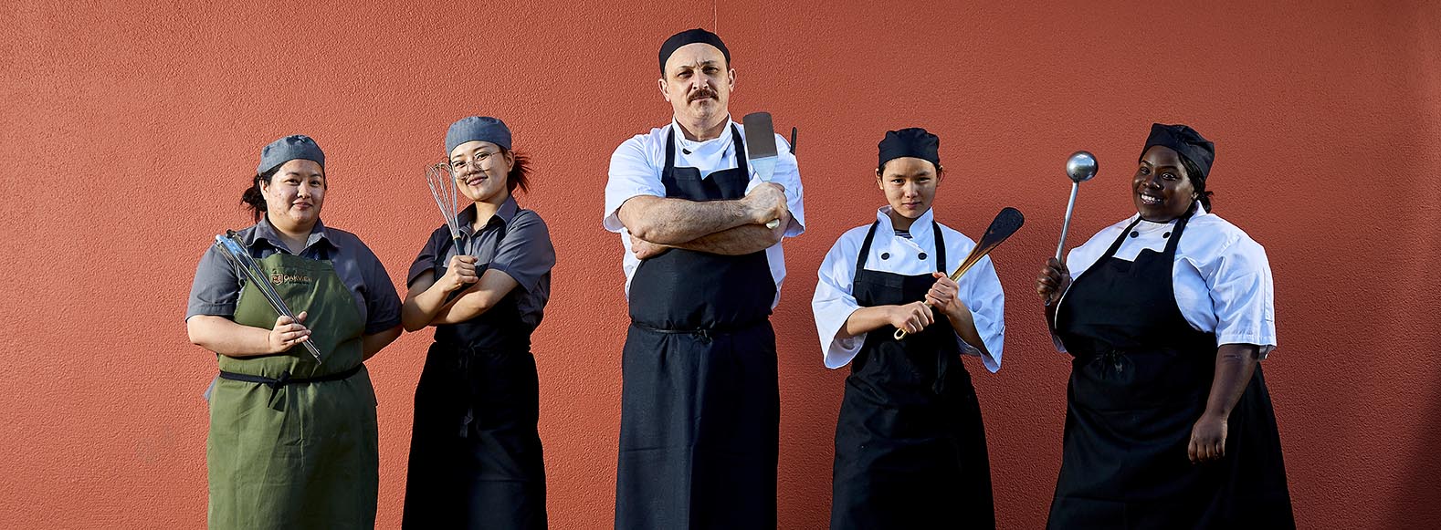 chefs infront of red brick wall